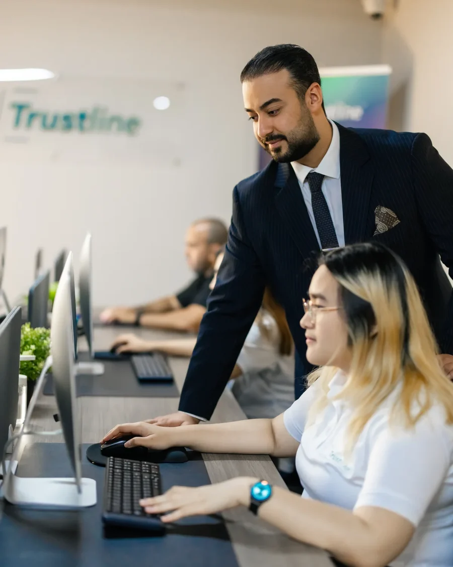 Ali Owji working alongside a member of the Trustline team.